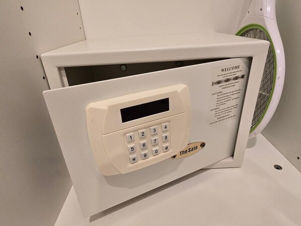 Una caja fuerte con teclado y puerta verde y blanca.