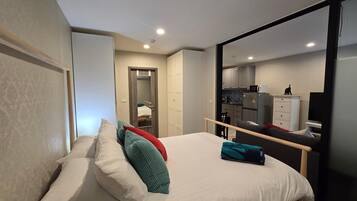 Apartment, Balcony, Pool View | In-room safe, blackout curtains, iron/ironing board, free WiFi