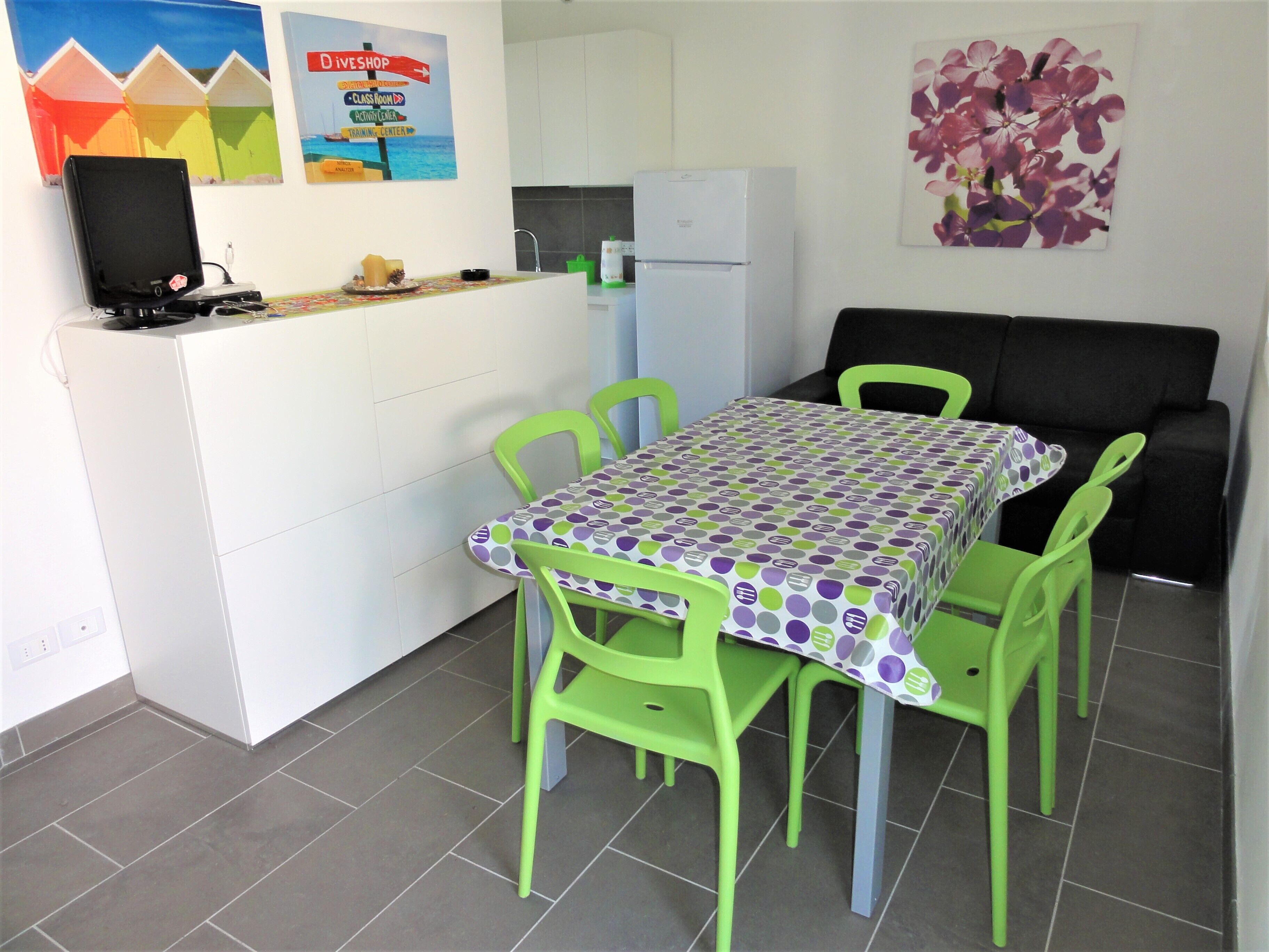 A compact kitchen with a dining area.
