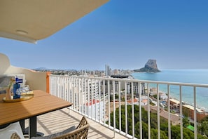 Ein Balkon mit Blick auf eine Küstenstadtlandschaft, einschließlich einer markanten Felsformation.