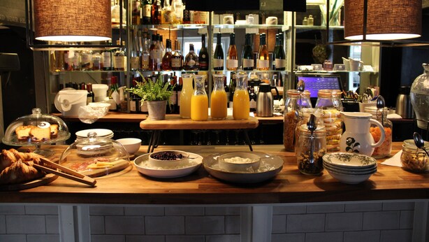 A breakfast buffet with various food items and beverages, including pastries, fruits, and a selection of juices. - The Greyhound on the Test (Stockbridge)