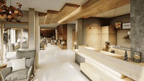Un moderno vestíbulo de hotel con vigas de madera, un mostrador de recepción, zonas de estar y una chimenea.