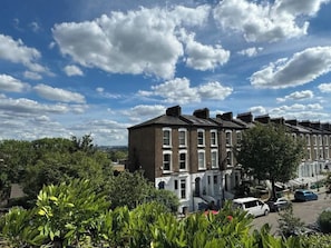 A row of terraced houses with a clear sky and some clouds.