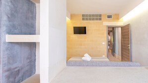 A modern bathroom with a bathtub, a towel, and a wall-mounted TV. - Apartment 'Biancomare Otranto - Apt 2' with Balcony, Wi-Fi and Air Conditioning (otranto)