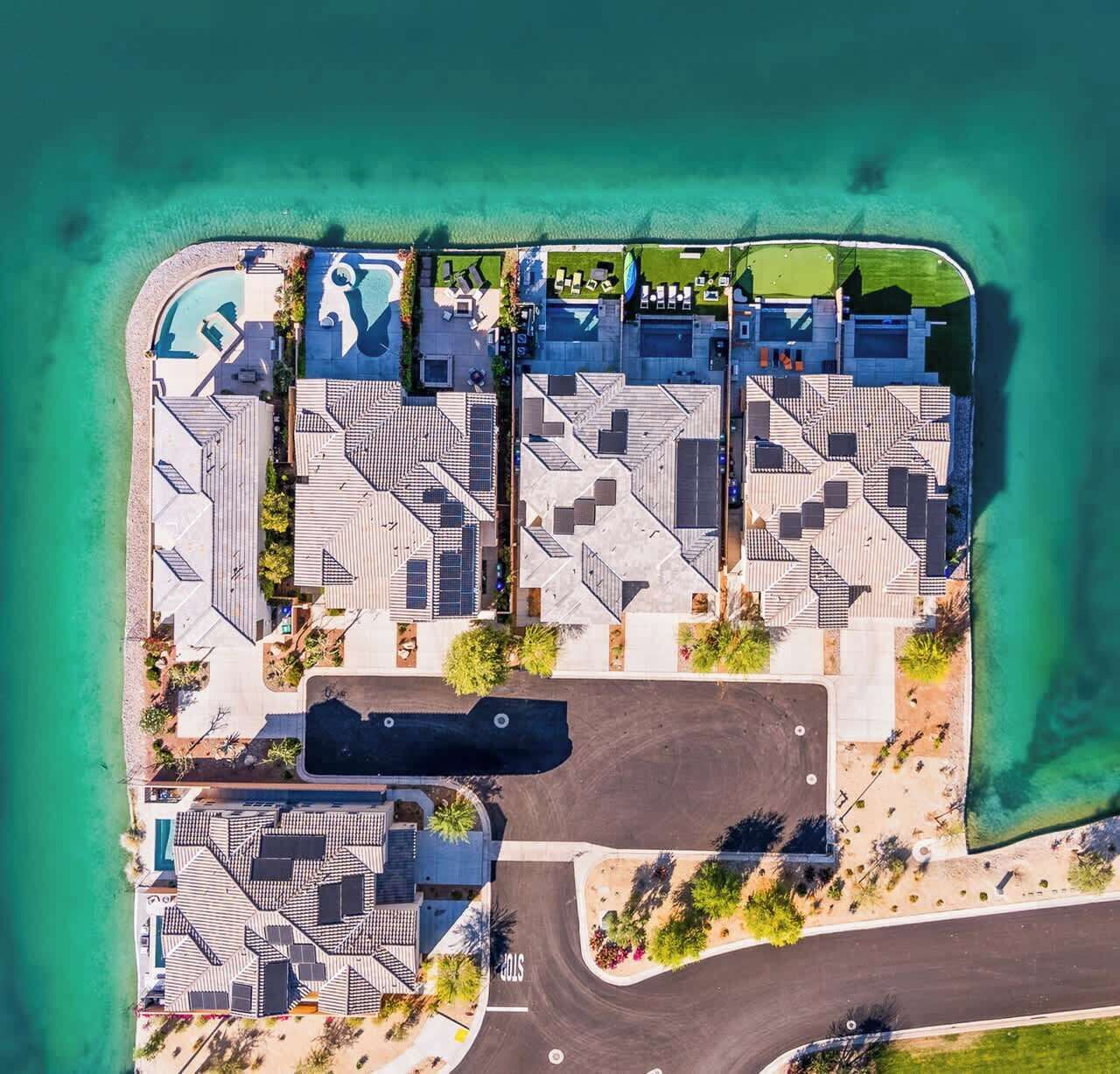 An aerial view of a coastal hotel with multiple buildings, a swimming pool, and a beach area.