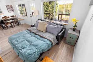 A bedroom with a bed, a desk, and a chair. - Home on golf course pond. Hike. Swim. Golf! (Star Valley Ranch)