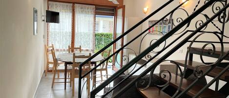 A staircase with ornate metal railings leading to a landing.