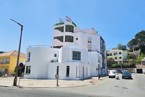 A white hotel with a distinctive tower and a sign that reads 'HOTEL LAPA'. - Hotel Laitau (Nossa Senhora da Anunciada)