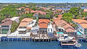 A coastal residential area with houses, a marina, and a hotel.