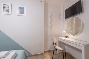A modern bathroom with a white vanity, a round mirror, and a mounted TV. - Stylish 2Bedroom Apt at the foothills of Acropolis (Athina)
