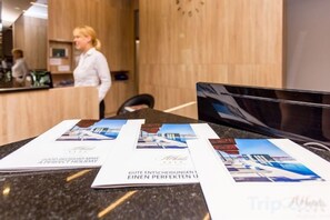 A reception desk with brochures and a digital screen. - Hotel Plaža Duće (Duce)