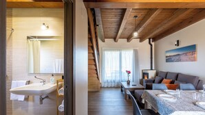 A modern interior with a bathroom, dining area, and living space. - Villas Spa el Mirador de Isla (Isla)