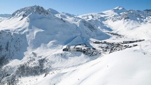 A snow-covered mountain with a small town nestled in the valley. - Apartment in Le Lavachet With Ski Access (Tignes)