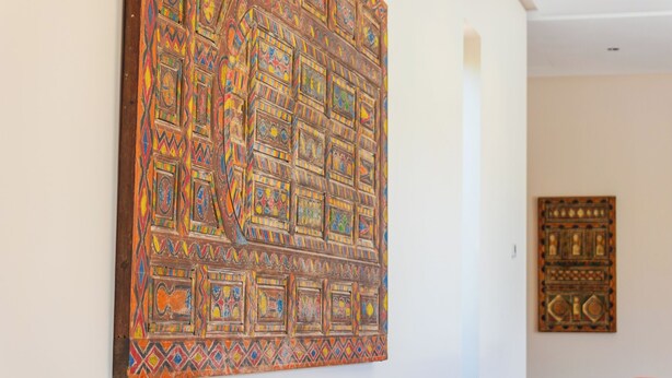 A room with a large, colorful abstract painting on the wall and a smaller framed artwork below it. - Villa Jamila Marrakech - Authentic luxury and heated private pool. (Marrakech)