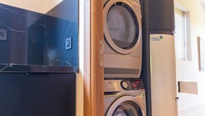 A laundry room with a front-loading washing machine, a dryer, and a stacked washer and dryer unit. - Villa Jamila Marrakech - Authentic luxury and heated private pool. (Marrakech)