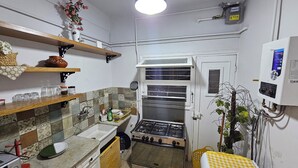A compact kitchen with a gas stove, a water heater, and a sink. - Simple sea view (families only) (Alexandria)