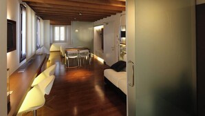A modern interior with a wooden ceiling, a dining area with chairs and a table, a sofa, and a TV. - Villa Veneta Ca' Sabbioni  (Mestre)