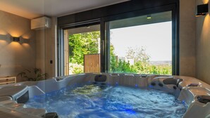 A hot tub with a view of greenery outside. - Blacksmith House - Stylish vacation home with spa & nature views (Varaždinske Toplice)