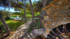 A stone staircase leading to a wooden deck with a view of a pond and trees. - Amadria Park Sibenik Beach Villa for 7 persons (Sibenik)