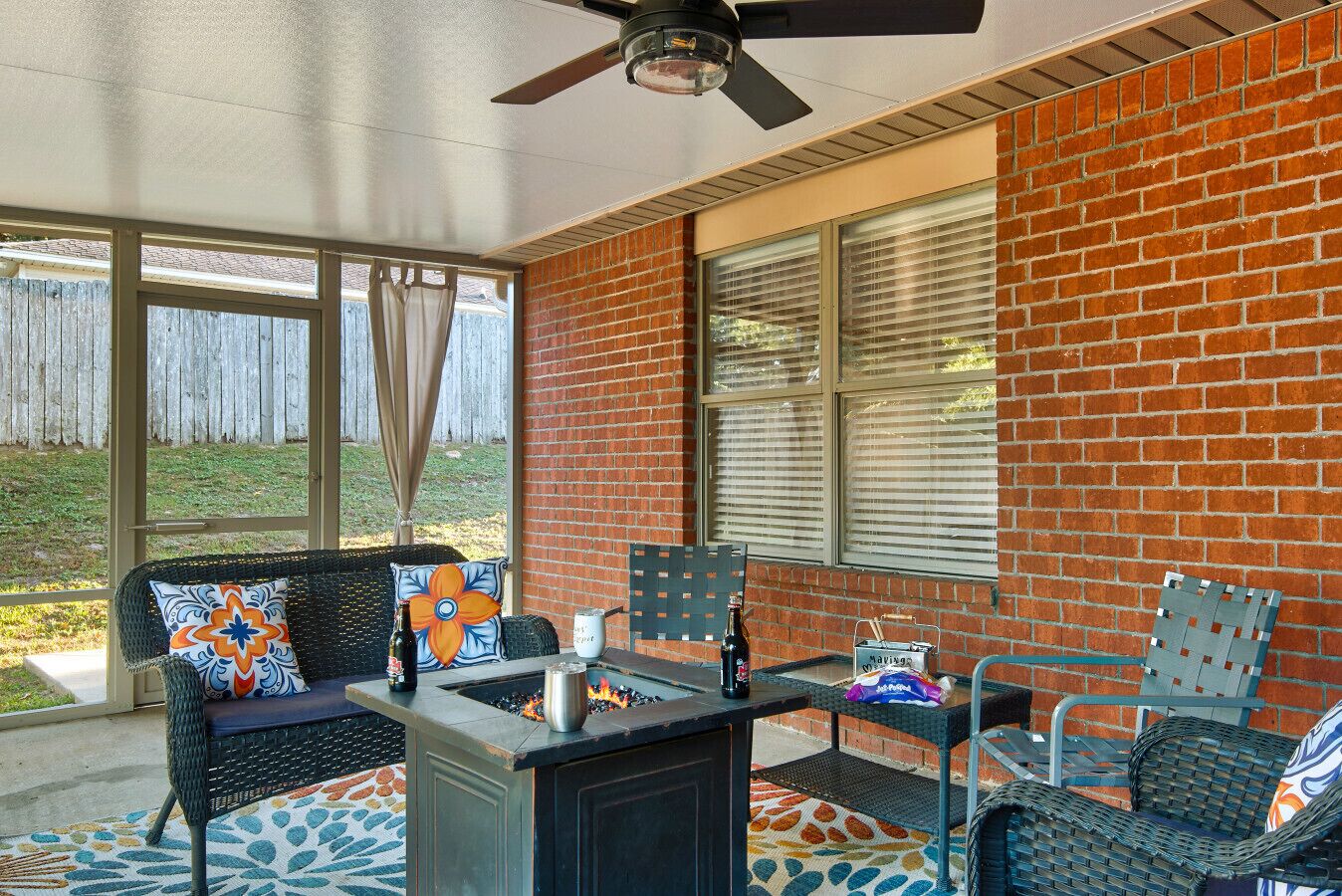Screened Patio | Cozy Outdoor Lounge with Fire Pit, Wicker Seating & Vibrant Décor
