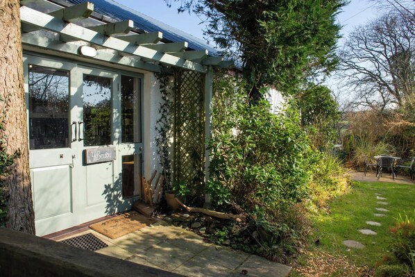 A building with a door labeled 'Bevvy,' a pergola, and a garden with a pathway. - Y Beudy at Coed Melin, Aberporth (Aberporth)
