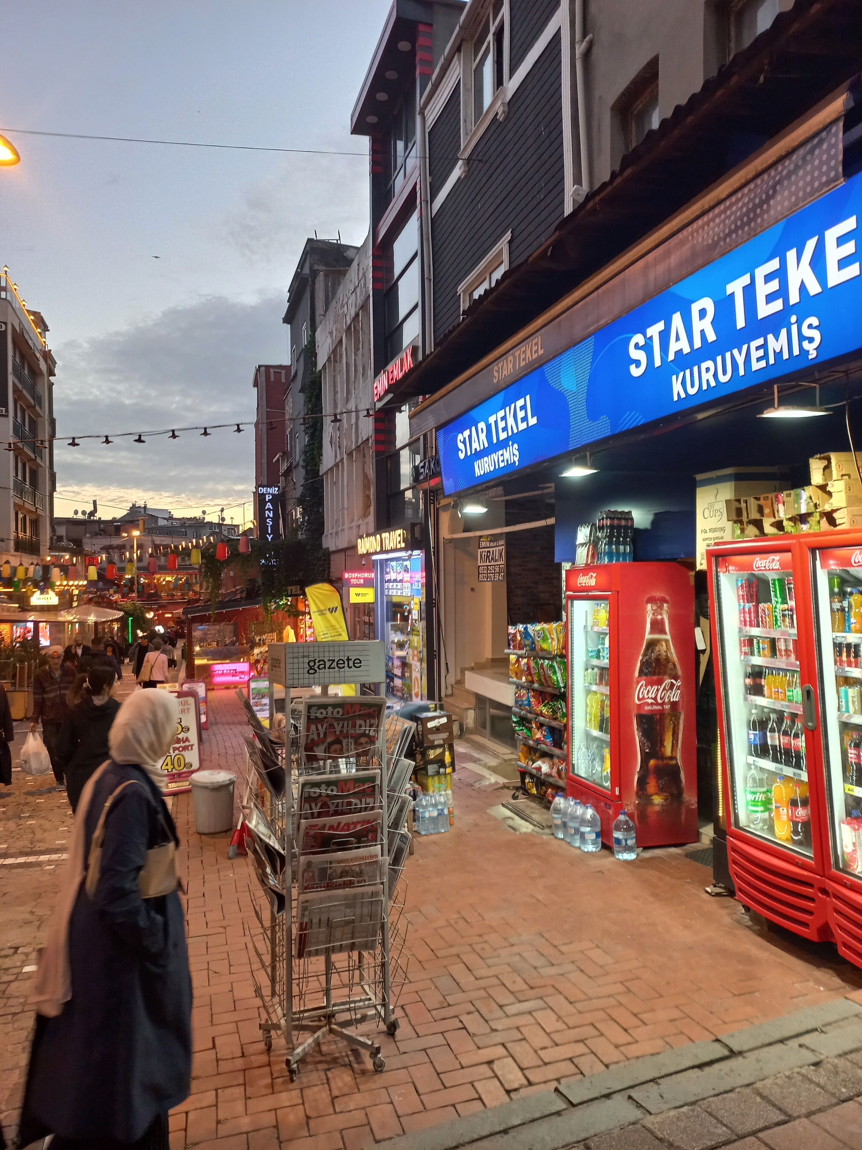A street scene with a storefront named "Star Tekel" and a Coca-Cola vending machine.