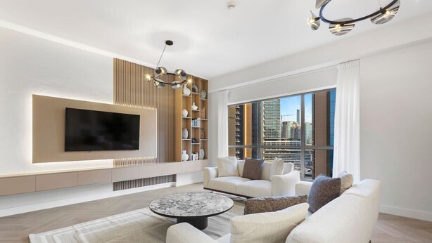 A modern living room with a flat-screen TV, a round coffee table, and a sofa set. - Cozy 3 Bedroom with walking access to JBR Beach (Jumeirah Beach Residence (JBR))