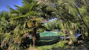 A swimming pool surrounded by lush greenery and trees. - Villa Glicini - Delightful Cottage With Pool (Ostra)