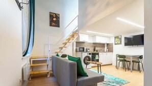 A modern apartment with a living room, kitchen, and dining area.