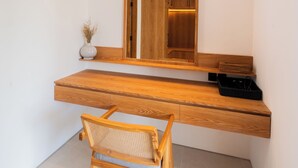 A modern bathroom with a wooden vanity, a mirror, and a chair. - Modern 3br Villa with Rooftop Patio - Pool Table (South Kuta)