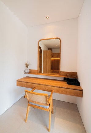 A modern bathroom with a wooden vanity, a mirror, and a chair. - Modern 3br Villa with Rooftop Patio - Pool Table (South Kuta)