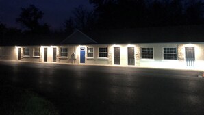 A two-story building with a flat roof, multiple windows, and a central door. - All-inclusive studio apartment with utilities included-Unit 5 (Waterville)