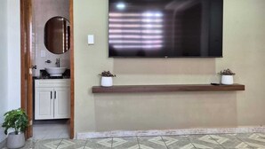 A bathroom with a sink, mirror, and potted plants. - House with large kitchen, 1 block from third ring road (Aguascalientes)