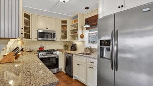 A kitchen with white cabinets, a stainless steel refrigerator, a microwave, a stove, and a dishwasher. - Escape to the mountains in this cozy yet luxurious 3-bedroom, 2-bath retreat tucked away in the gated Bent Tree community of Jasper, GA! (Jasper)