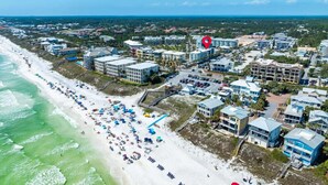 An aerial view of a coastal town with a beach, buildings, and a red location marker. - Salty's Six Palms 4A (Santa Rosa Beach)