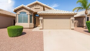 A residential house with a garage, a well-maintained lawn, and a palm tree. - Near stadiums and sports complex, Peoria Oasis (Peoria)