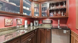 A kitchen with wooden cabinets, a granite countertop, stainless steel appliances, and a 'Happy Hour' sign. - Private Guest Suite in Beautiful Kirkland, West of Market neighborhood. (Kirkland)