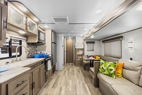 Super- fun camper with plenty of room for a full-size family, lots of comfy beds + full kitchen, bath, and separate bedroom for Mom & Dad.  There's even a nice patio with outdoor kitchen and seating area for barbecues, bacon & eggs in the morning, et