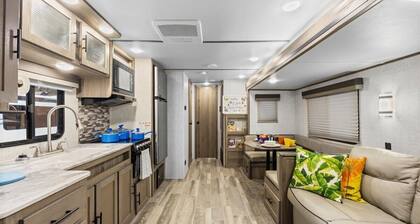 Super- fun camper with plenty of room for a full-size family, lots of comfy beds + full kitchen, bath, and separate bedroom for Mom & Dad. There's even a nice patio with outdoor kitchen and seating area for barbecues, bacon & eggs in the morning, et