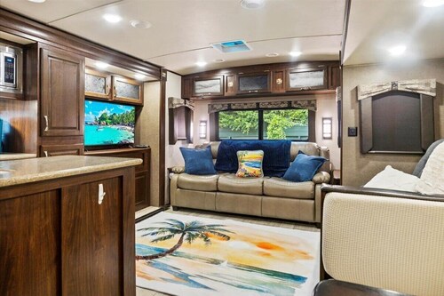 Spacious luxury RV with large kitchen/living room area, private bedroom w/king-size bed, bath and 1/2, with a deck, located in a beautiful RV resort with tons of amenities. Min. stay is 2 nights w/weekly and monthly discounts.  Monthly rate is $1,600