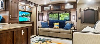 Spacious luxury RV with large kitchen/living room area, private bedroom w/king-size bed, bath and 1/2, with a deck, located in a beautiful RV resort with tons of amenities. Min. stay is 2 nights w/weekly and monthly discounts. Monthly rate is $1,600