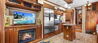 THIS IS AN AWESOME 36' RENTAL CAMPER WITH AMAZING LONG DECK, PLUS A SECOND STEP-DOWN DECK TO YOUR OWN PRIVATE HIDEAWAY TIKI BAR!  A BEAUTIFUL HUGE LIVE OAK COVERS THE ENTIRE LOT SO IT'S ALWAYS SHADED, AND THIS EVEN COMES WITH A TABLE & CHAIRS FOR OUT