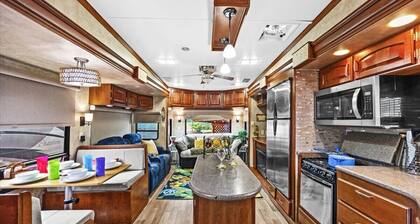 THIS IS AN AWESOME 36' RENTAL CAMPER WITH AMAZING LONG DECK, PLUS A SECOND STEP-DOWN DECK TO YOUR OWN PRIVATE HIDEAWAY TIKI BAR! A BEAUTIFUL HUGE LIVE OAK COVERS THE ENTIRE LOT SO IT'S ALWAYS SHADED, AND THIS EVEN COMES WITH A TABLE & CHAIRS FOR OUT