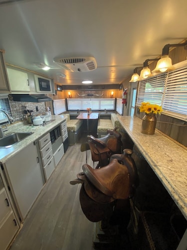 The "Bunkhouse" (western-themed glamper) sleeps 2 to 4 avg size people.  There's even a bar with real western saddles for barstools! All new electric appliances, so super-easy to "glamp" in a beautiful, treed area of the park. Access to the park's am