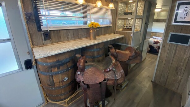 A bar area with wooden barrels, a counter, and a rustic decor.