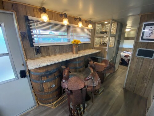 The "Bunkhouse" (western-themed glamper) sleeps 2 to 4 avg size people.  There's even a bar with real western saddles for barstools! All new electric appliances, so super-easy to "glamp" in a beautiful, treed area of the park. Access to the park's am