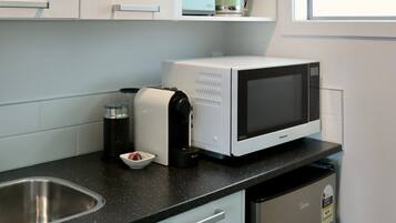 Microwave, coffee/tea maker, toaster, cookware/dishes/utensils
