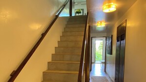 A staircase with wooden handrails leading to an upper floor.