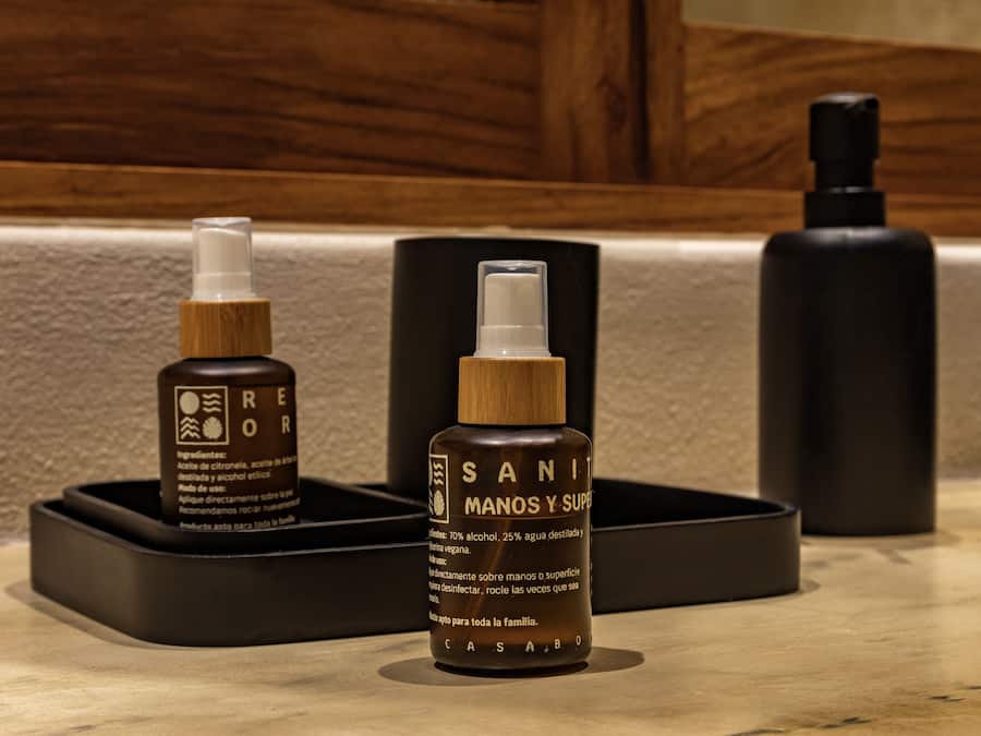 A bathroom counter with three bottles of hand sanitizer.