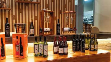 A wine bar with various bottles and glasses displayed on wooden shelves and counters.